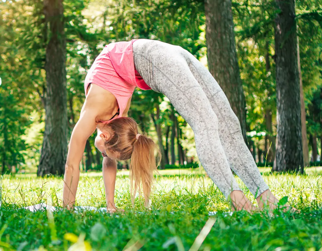 A woman doing yoga, showing back flexibility