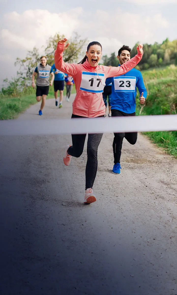 A woman running across the finish line