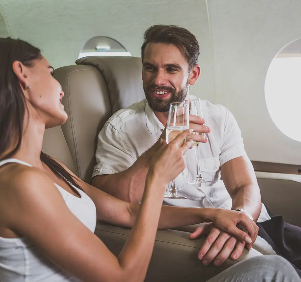 A couple enjoying drinks during a flight